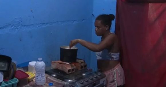 Mulher compra álcool combustível para cozinhar após aumento no preço do gás em Salvador
